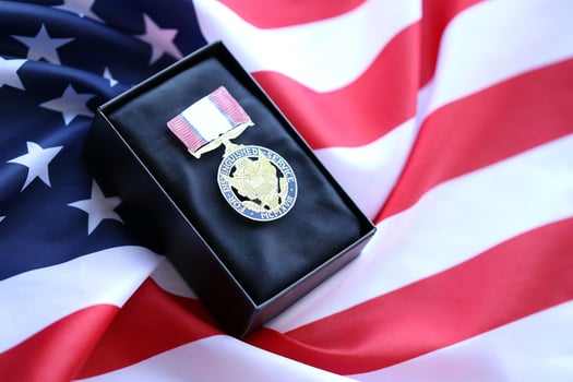 KYIV, UKRAINE - JULY 10, 2024 Distinguished Service medal. United States military award medal with ribbon and pin. Handmade paper theater props photo