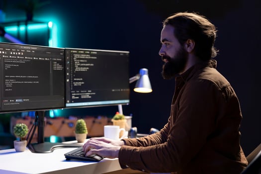 Freelancing computer engineer typing on keyboard, implementing security measures to protect company systems and data. Remote IT worker testing and debugging code for software applications photo