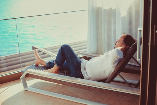 Relaxed young man at home on the balcony photo