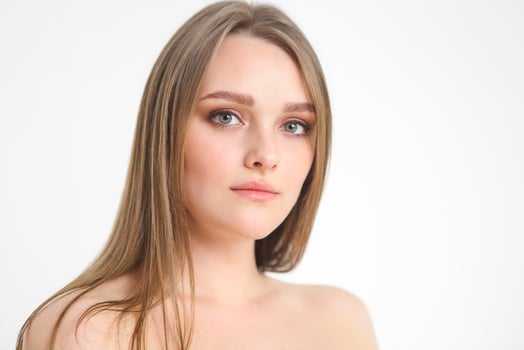 Beautiful plus size curly young blond woman posing on white photo