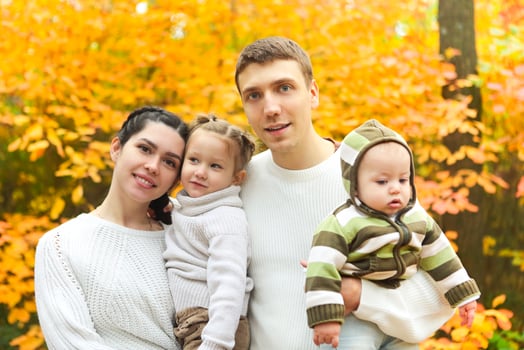 Smiling family with two children outdoors photo