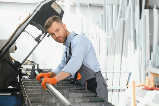 Profesional fabric worker. Metal processing plant. A worker at a metal profile warehouse. photo
