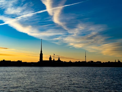 Stunning silhouette of St. Petersburg's skyline at sunset, featuring the Peter and Paul Fortress and other historic landmarks against a vibrant sky photo