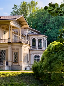 A beautifully preserved historic mansion in St. Petersburg, showcasing intricate architectural details and set against a backdrop of lush greenery. Perfect for themes of heritage, architecture, and cultural history photo