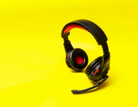 Wireless Over-Ear full size Headphones, Black leather isolated on yellow background with clipping path. photo
