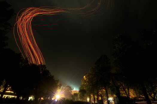 A Red Light Is Flying Through The Night Sky On Borobudur Temple photo