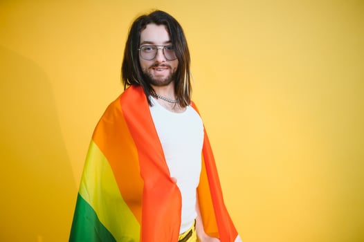 Young gay man is standing in the studio and posing for a camera. photo