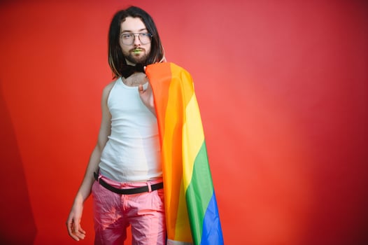 Gay man on a colored background in the studio. The concept of the LGBTQ community. Equality. photo