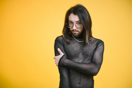 Gay man on a colored background in the studio. The concept of the LGBTQ community. Equality. photo