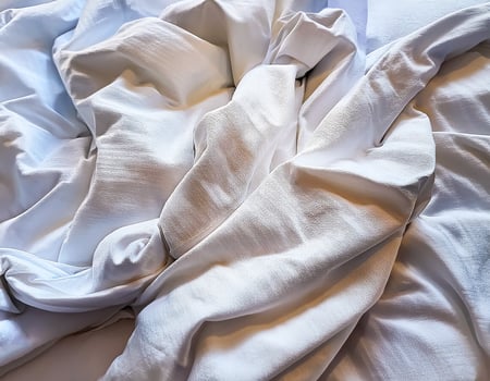 Background concept. Soft bed sheets that are still wrinkled after being used. The white bed sheets were crumpled and shabby. Pattern texture background. photo
