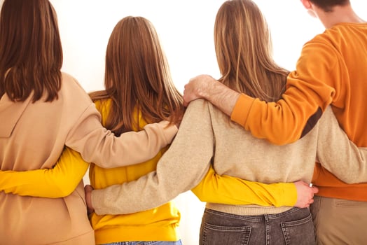 Unrecognizable friends hugging each other photo