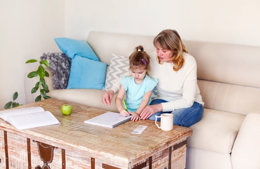 Grandmother teaching granddaughter to draw photo