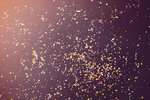 Colorful confetti on dark table photo