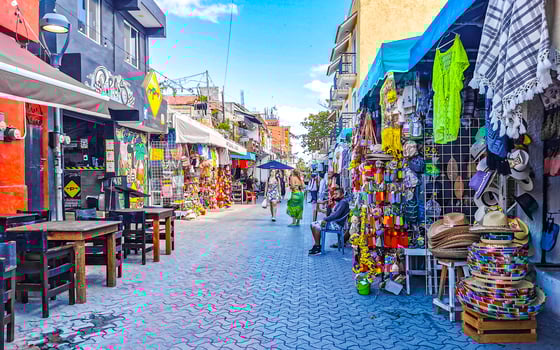 Typical colorful tourist streets sidewalks restaurants stores Isla Mujeres Mexico. photo