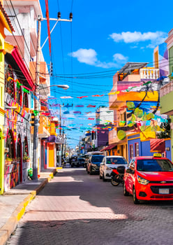 Typical colorful tourist streets sidewalks restaurants stores Isla Mujeres Mexico. photo