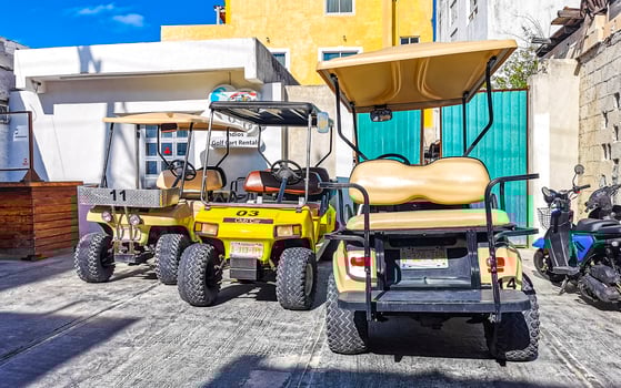 Gold cart rent drive tourist streets sidewalks Isla Mujeres Mexico. photo