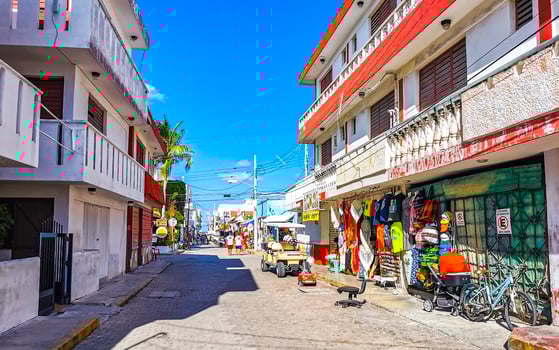 Typical colorful tourist streets sidewalks restaurants stores Isla Mujeres Mexico. photo