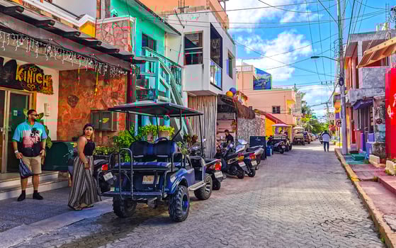 Gold cart rent drive tourist streets sidewalks Isla Mujeres Mexico. photo