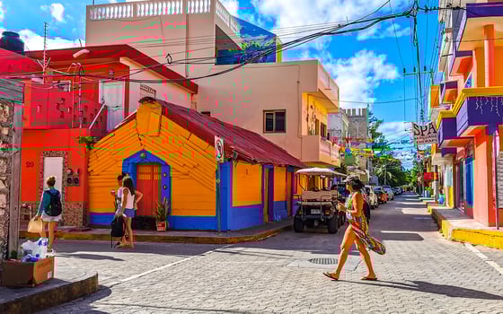 Typical colorful tourist streets sidewalks restaurants stores Isla Mujeres Mexico. photo
