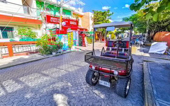 Gold cart rent drive tourist streets sidewalks Isla Mujeres Mexico. photo