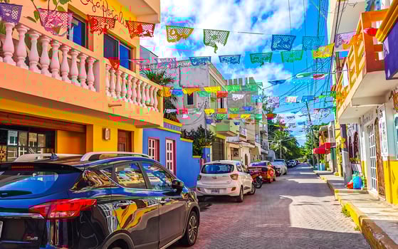 Typical colorful tourist streets sidewalks restaurants stores Isla Mujeres Mexico. photo
