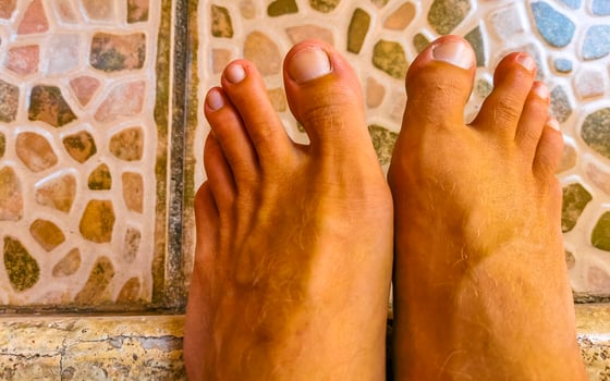 Man walks barefoot on the street in Mexico. photo