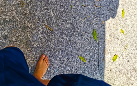 Man walks barefoot on the street in Mexico. photo