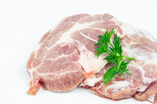 raw pork chops with herbs on white background photo