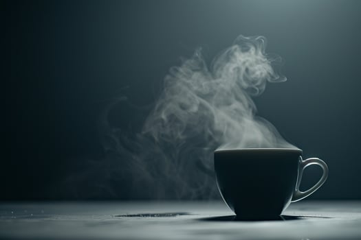 A Cup of Coffee is on a Table with Smoke Coming Out photo