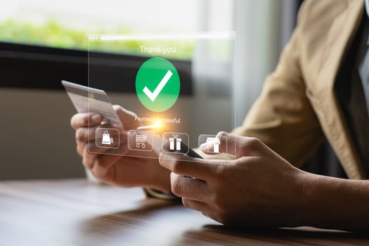 Person Making Online Payment with Credit Card on Laptop, Holographic Interface Showing Payment Successful and Shopping Icons, Representing E-commerce and Digital Transactions photo