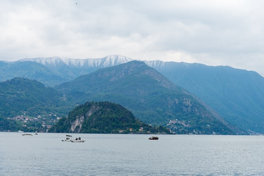 Lake como, Italy-April 26, 2024 Boats on Lake with Mountain Backdrop photo