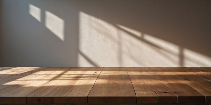 Empty Light Wood Table with Soft Shadow and Sun Rays on White Wall Background. photo