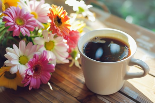 Cup of Coffee and Flowers on a Table Background photo
