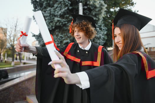 Portrait of two happy graduating students. photo