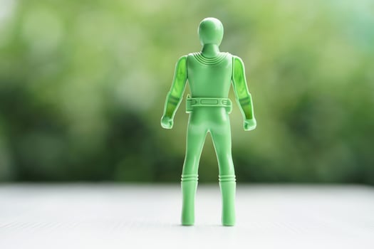 Green model of human plastic toy. Concept, Toy for kids, enhance imagination in childhood with toy characters of superhero. Fantasy comic fiction from cartoons, movie. photo