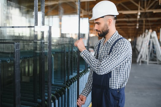 The glazier carries the glass in the glass factory. photo