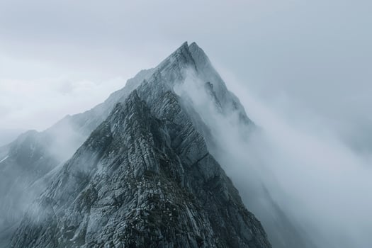 A Mountain Peak Covered in Fog Background photo