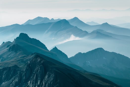 a mountain range with a foggy sky background photo