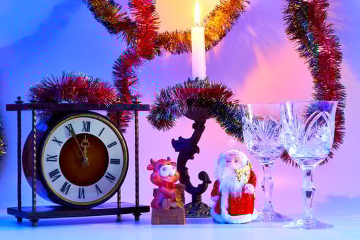 Happy New year.Santa Claus. vintage clock, wine glasses, burning candle photo