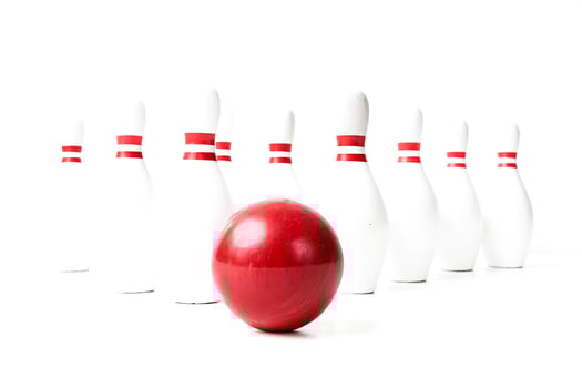 Red Bowling Ball in Front of White Pins photo