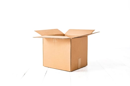 Open Cardboard Box on White Wooden Background photo