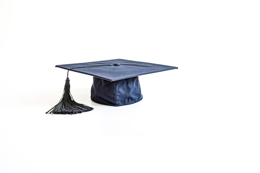Black Graduation Cap With Tassel on White Background photo