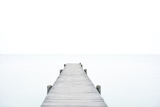 Wooden Dock Leading to a Hazy Horizon photo