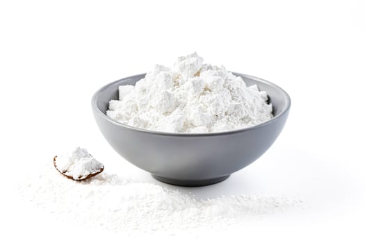 Close-up of a bowl of cornstarch on a white background photo