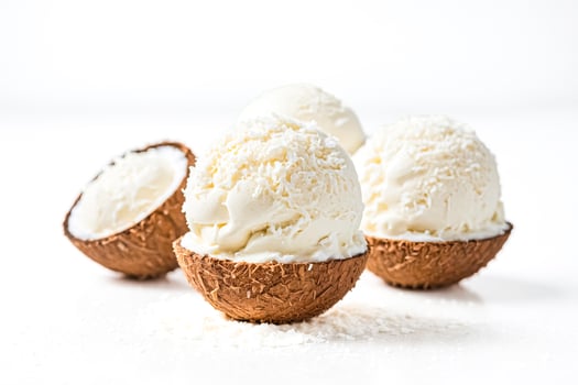 Coconut ice cream scoops in coconut shells on white background photo