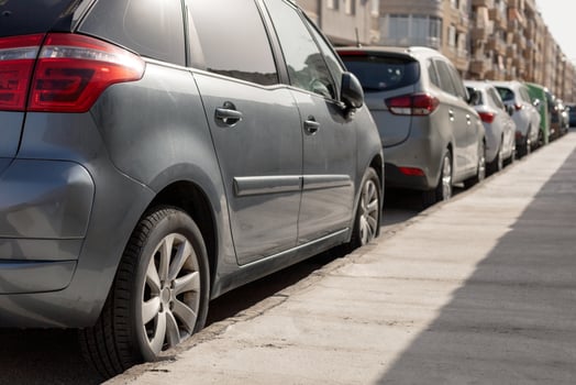 Row of diverse cars parked along urban street, illustrating the typical scene in city parking zone. Ideal for urban planning articles, parking management content, transportation theme illustrations. photo