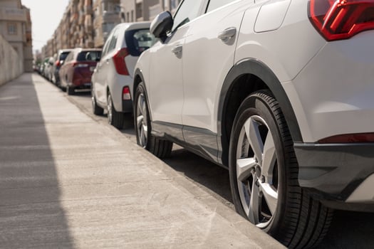 Row of diverse cars parked along urban street, illustrating the typical scene in city parking zone. Ideal for urban planning articles, parking management content, transportation theme illustrations. photo