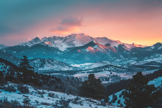 a beautiful sunset over the mountains background photo