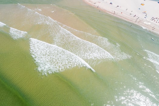 aerial zenithal view from a drone of the shore of a beach in summer, with turquoise sea water. photo