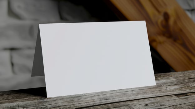 Blank white business card on a wooden table. photo
